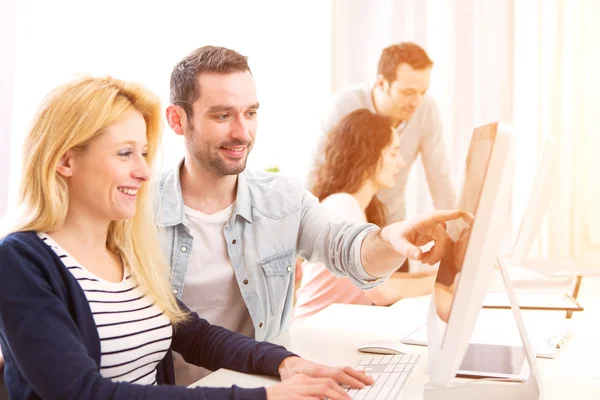 Young attractive people working together at the office — Stock Photo, Image