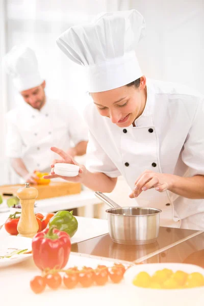 Young attractive professional chef cooking in his kitchen — Stock Photo, Image