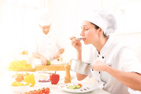Young attractive professional chef cooking in his kitchen — Stock Photo, Image