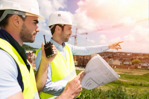 Worker and architect watching some details on a construction — Stock Photo, Image