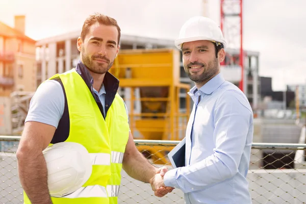 Worker and architect watching some details on a construction — Stock Photo, Image