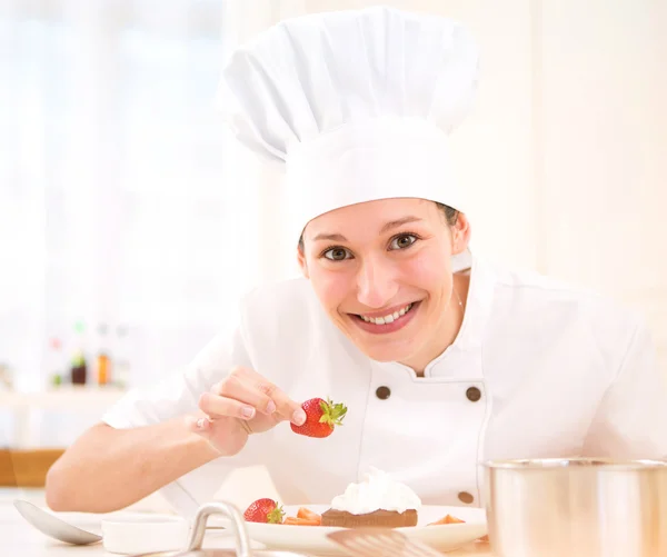 Young attractive professional chef cooking in his kitchen — Stock Photo, Image