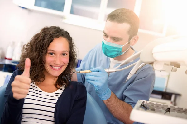 Young attractive woman being cured by a dentist — Stock Photo, Image