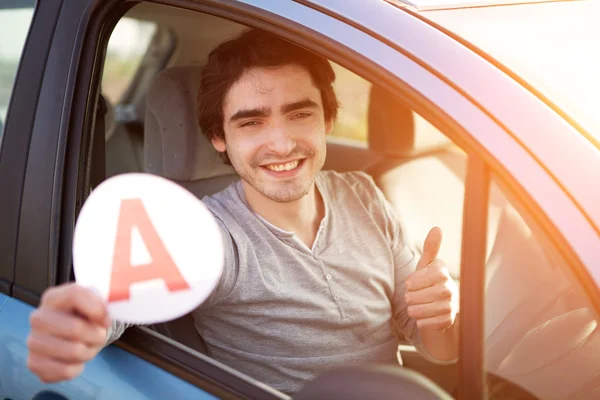 Young man happy to get his driving license — Stock Photo, Image