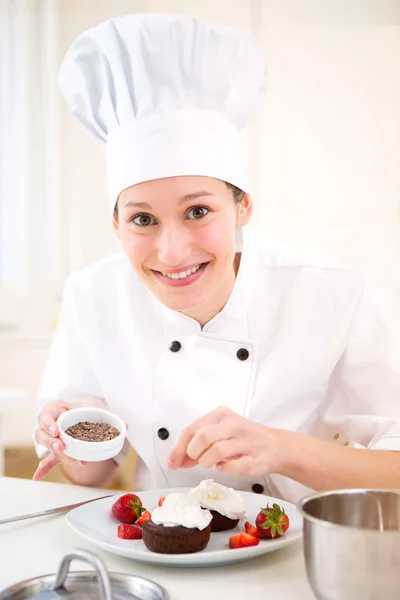 Young attractive professional chef cooking in his kitchen Stock Image