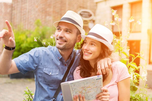 Couple of young attractive tourists discovering city on holidays — Stock Photo, Image