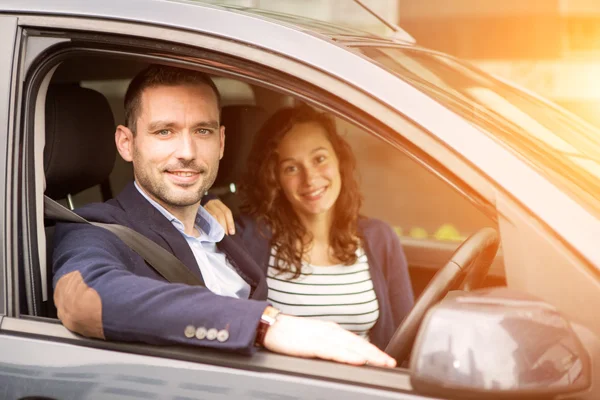 Young business man couple in their brand new car — Stock Photo, Image