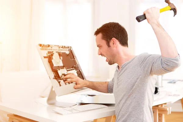 Young attractive man repairing a computer — Stock Photo, Image