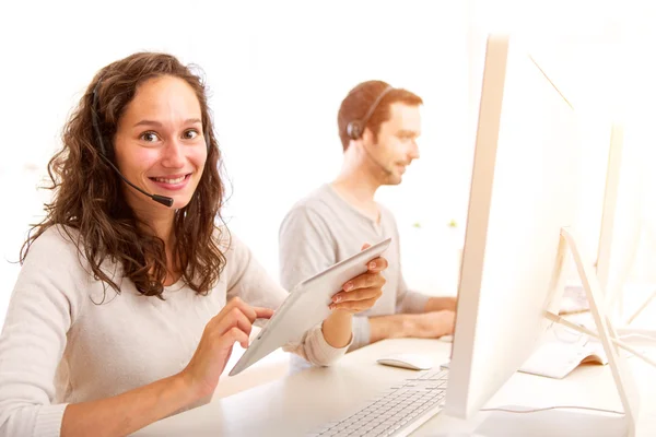 Young attractive woman working in a call center — Stock Photo, Image