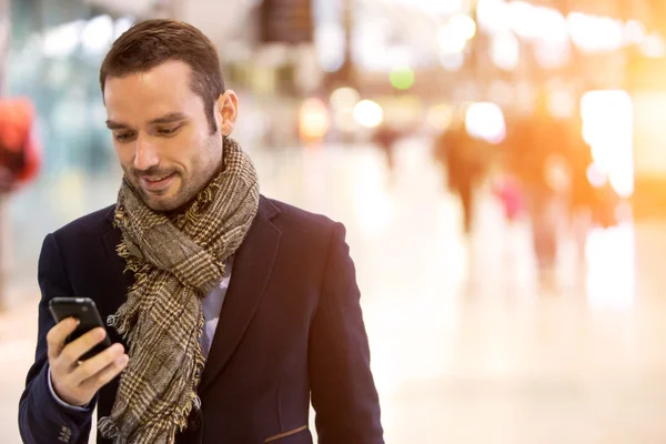 Young attractive man transiting a railway station — Stock Photo, Image