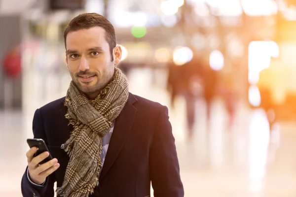 Young attractive man transiting a railway station — Stock Photo, Image