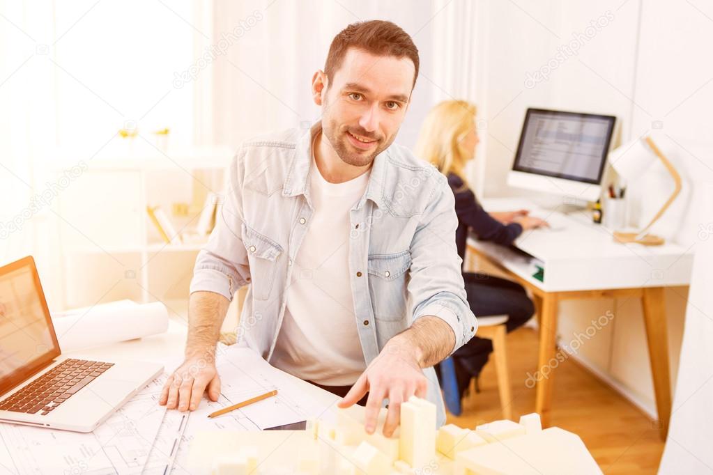 Young attractive architect working at the office 