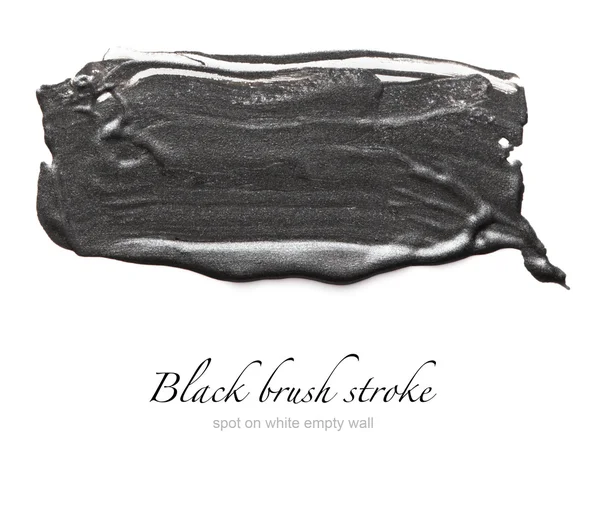 Black brush stroke on white empty wall — Stock Photo, Image