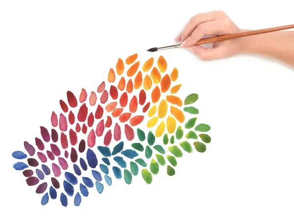 Hand with paint brush and color painted background — Stock Photo, Image