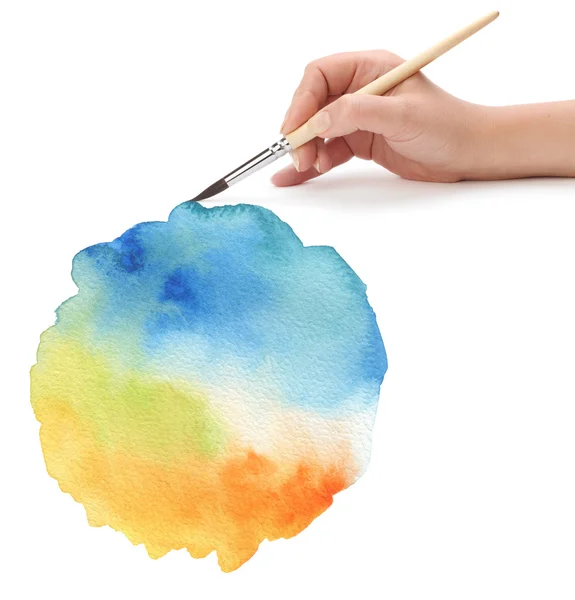 Hand with paint brush and color painted background — Stock Photo, Image