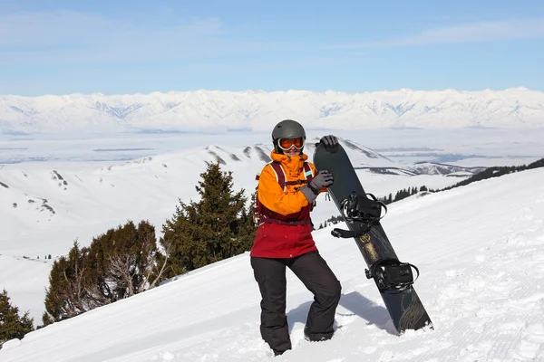 Girl with snowboard on a mountain — Stock Photo, Image