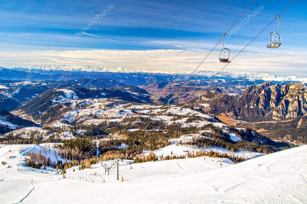 Ski lift and slope in Dolomites mountains, Carezza / Karersee ski resort area, Italy, South Tyrol