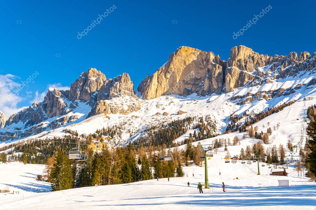Ski lift and slope in Dolomites mountains, Carezza / Karersee ski resort area, Italy, South Tyrol