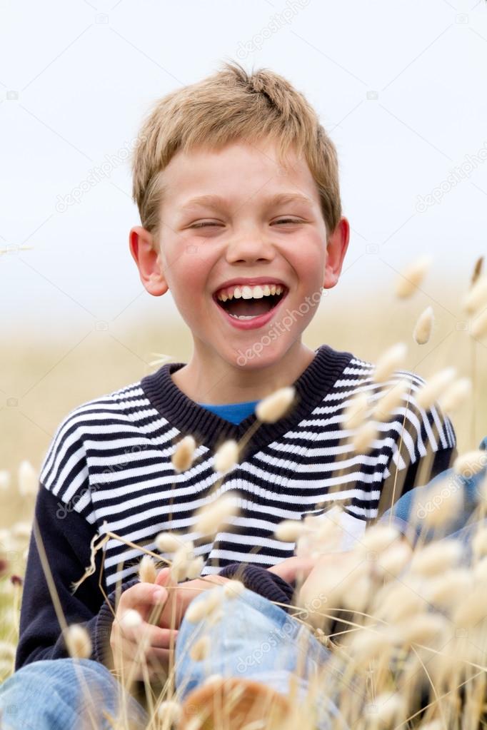 blond child laughing in nature