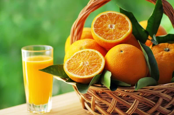 Pomarańczowy owoc kosz i sok szkło — Zdjęcie stockowe