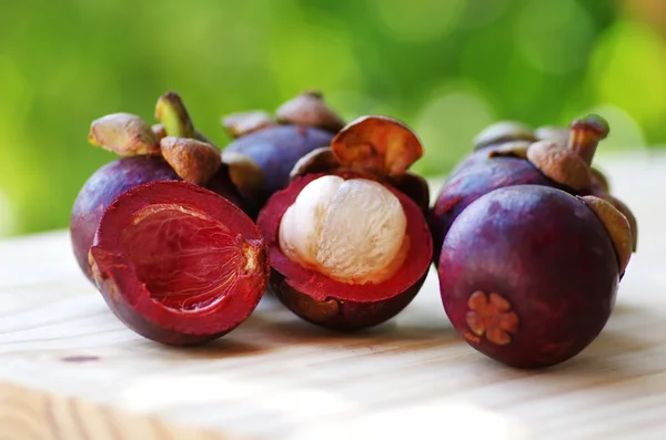 Fresh mangosteen fruit on wooden table
