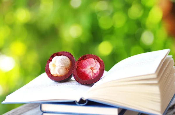 Sliced mangosteen on a book — Stock Fotó