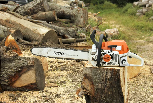 Stihl Chainsaw on a log outdoors — Stock Fotó