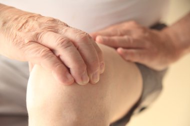 Adam diz üzerinde el ile