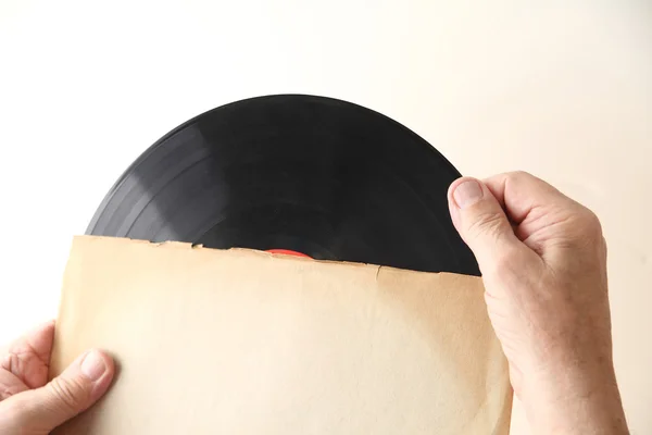 Man tiene disco de vinilo en la manga —  Fotos de Stock