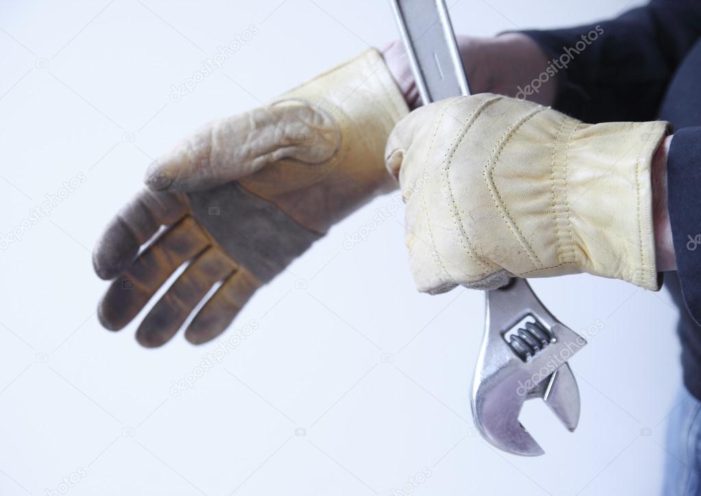 Man with wrench and gloves