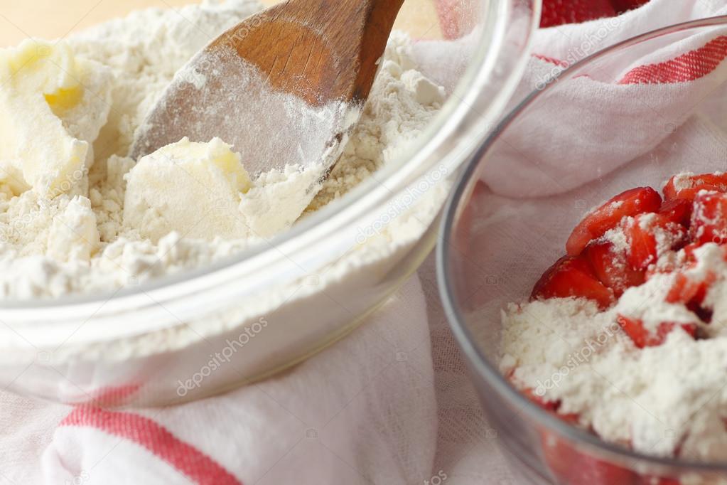 Butter, flour, bowls and strawberries