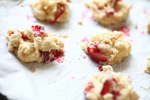 Strawberry biscuits on parchment — Stock Photo, Image