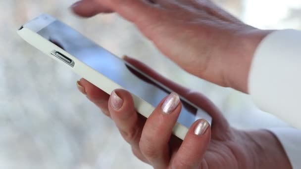 Woman holds white cell phone. — Stock Video