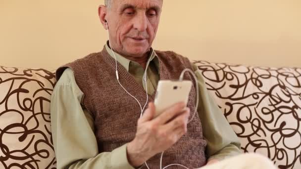 Старший чоловік з білим смартфоном — стокове відео