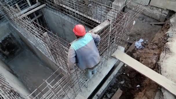 Builder with red hard hat at project site. Building of foundation — Stock Video