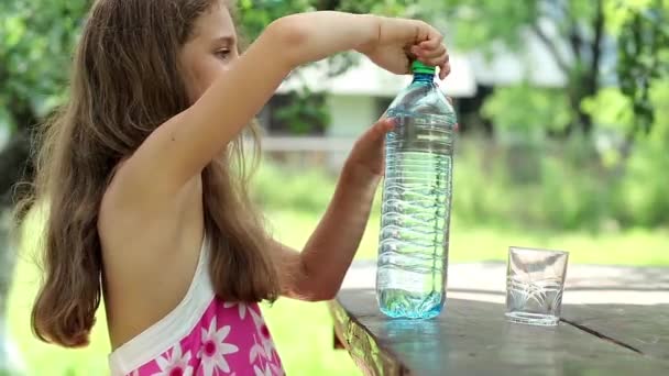 Pretty girl pours water into a glass — Stock Video