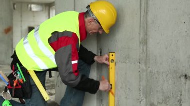 Worker in hard hat with level