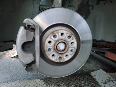 Fren diski ve fren pedleri. Bir yolcu vagonunun yapısı. Benzin istasyonundaki araba. Tekerlek sökülmesi ve onarılması