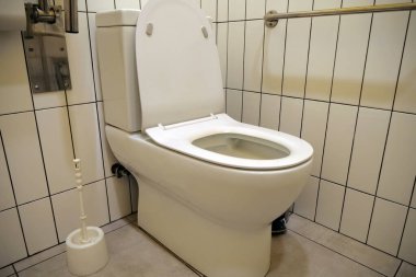 Engelliler, engelliler için tuvalet. Tuvalette çok yer var ve parmaklık var.