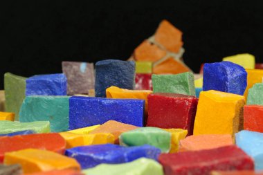 Küçük olan, dekoratif ve uygulamalı sanat eserlerinde, mücevher de dahil olmak üzere, mozaik yapımında kullanılan, küçük küp veya plaka şeklinde mat camdır. Eski mozaiklerden çok renkli küçük