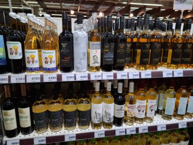 KYIV, UKRAINE, Kasım 7, 2025: Süpermarket raflarında farklı alkollü ürünler. Birçok alkollü içecek şişesi bir mağazanın alkollü içecekler bölümünde raflarda duruyor.