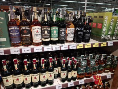 KYIV, UKRAINE, Kasım 7, 2025: Süpermarket raflarında farklı alkollü ürünler. Birçok alkollü içecek şişesi bir mağazanın alkollü içecekler bölümünde raflarda duruyor.