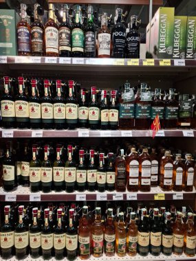 KYIV, UKRAINE, Kasım 7, 2025: Süpermarket raflarında farklı alkollü ürünler. Birçok alkollü içecek şişesi bir mağazanın alkollü içecekler bölümünde raflarda duruyor.