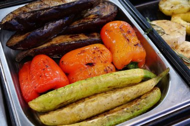 Kırmızı biber, yeşil kabak ve siyah patlıcan. Fast food restoranında çeşitli kızarmış yiyecekler.