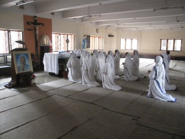 Sisters of Mother Teresa's Missionaries of Charity in prayer in the chapel of the Mother House, Kolkata clipart