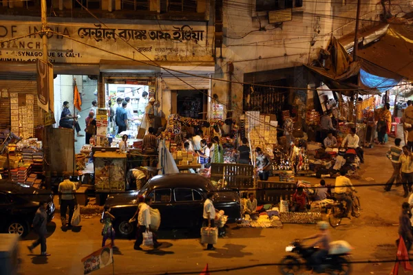El tráfico oscuro de la ciudad se desdibujó en movimiento al atardecer en las calles llenas de gente, Kolkata, India — Foto de Stock