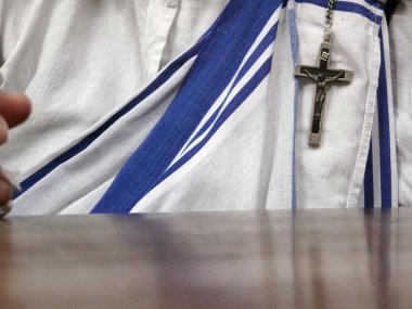 The white sari with blue stripes and a crucifix are recognizable sign of the Missionaries of Charity, Kolkata