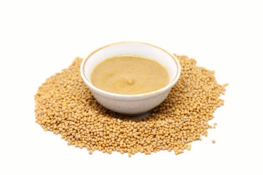 Hardal tohumlu bir kasede hardal sosu. Beyaz arkaplanda izole