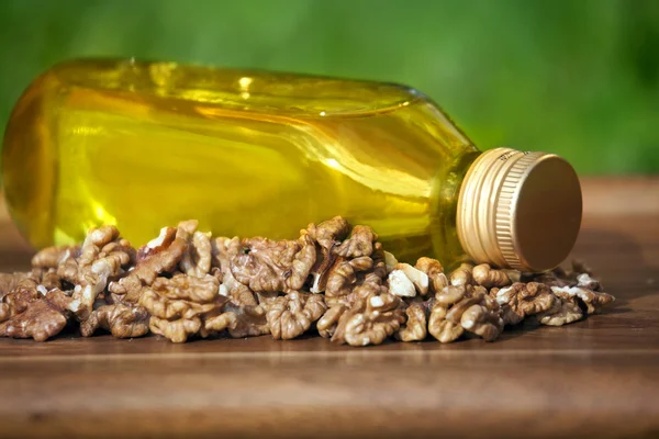 Walnut oil in bottle and nuts — Stock Photo, Image