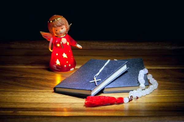 Christian books with a cross, beads and a figure of an angel — Stock Photo, Image